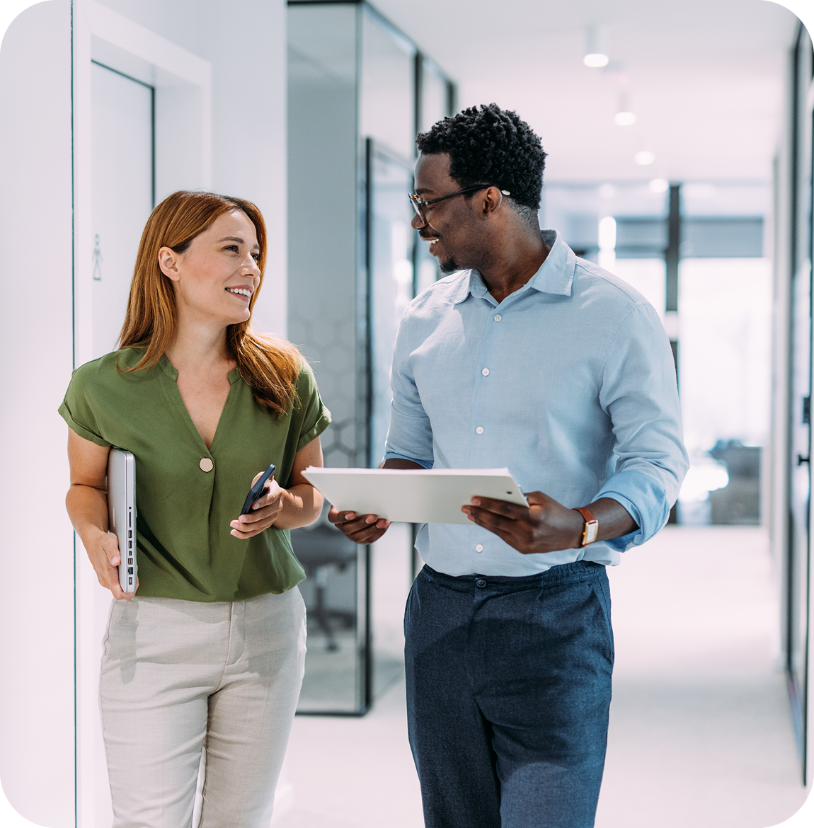 Business colleagues walking and talking in office